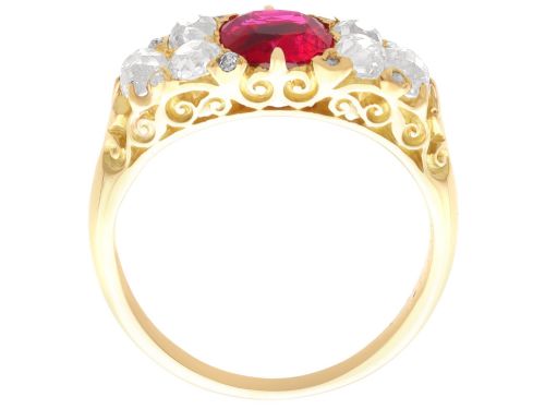 fig 6. An 18ct yellow gold dress ring featuring a central cushion-cut red ruby flanked by old cut diamonds with carved scrollwork setting.
