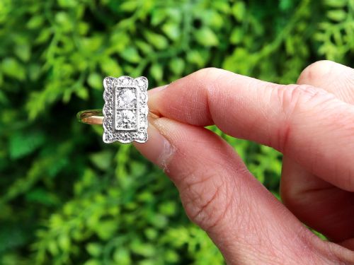 fig 1. An Art Deco 18ct yellow gold dress ring with two central round diamonds within a rectangular millegrain halo setting.