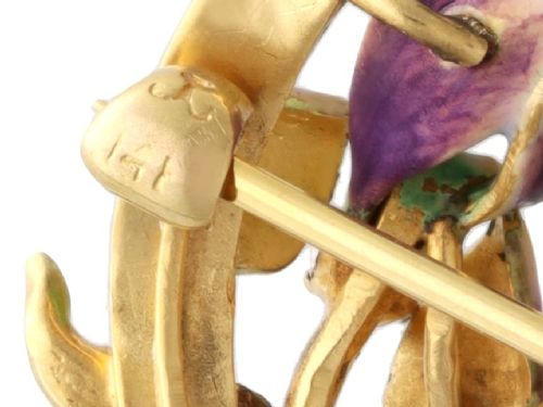 An Art Nouveau 18ct yellow gold brooch detailing a maiden profile framed by green enamel foliage and a purple enamelled iris set with a single diamond. View XI