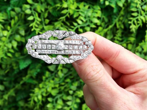 fig 1. An Art Deco platinum brooch styled in an elongated geometric openwork plaque pattern, set throughout with brilliant and square-cut diamonds.