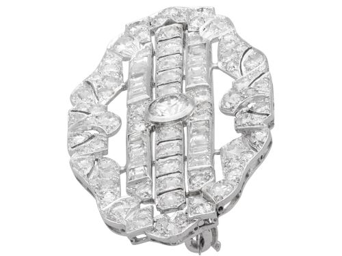 fig 5. An Art Deco platinum brooch styled in an elongated geometric openwork plaque pattern, set throughout with brilliant and square-cut diamonds.