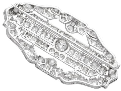 fig 7. An Art Deco platinum brooch styled in an elongated geometric openwork plaque pattern, set throughout with brilliant and square-cut diamonds.