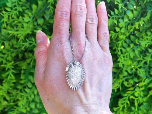 fig 1. A 1950s vintage white gold organic pendant set with brilliant-cut diamonds and bordered by baguette-cut diamonds.