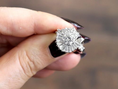 fig 2. An 18ct white gold Art Deco cocktail ring featuring a central round diamond surrounded by a fan of baguette diamonds and accent round diamonds.