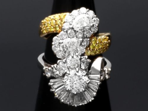 fig 4. An 18ct white gold Art Deco cocktail ring featuring a central round diamond surrounded by a fan of baguette diamonds and accent round diamonds.