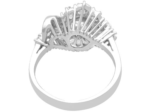 fig 7. An 18ct white gold Art Deco cocktail ring featuring a central round diamond surrounded by a fan of baguette diamonds and accent round diamonds.