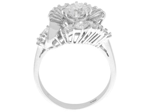 fig 8. An 18ct white gold Art Deco cocktail ring featuring a central round diamond surrounded by a fan of baguette diamonds and accent round diamonds.