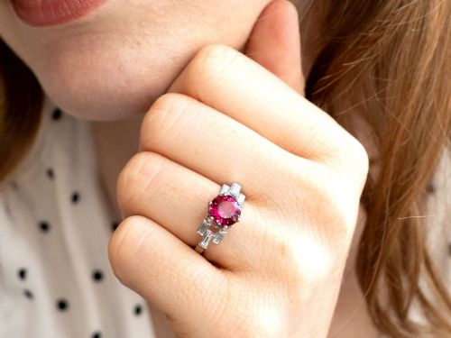 fig 3. An Art Deco platinum ring featuring a round pink tourmaline centre stone set between stepped shoulders of baguette-cut diamonds.