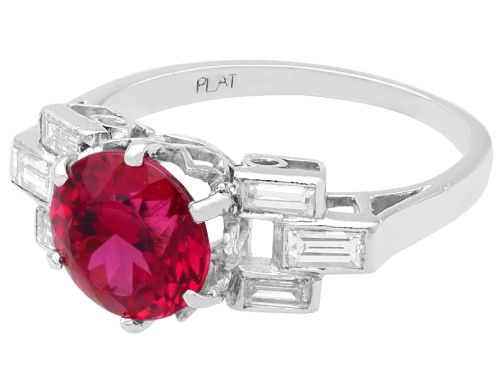 fig 6. An Art Deco platinum ring featuring a round pink tourmaline centre stone set between stepped shoulders of baguette-cut diamonds.