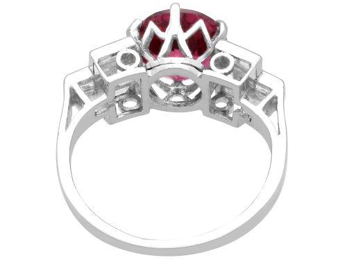 fig 7. An Art Deco platinum ring featuring a round pink tourmaline centre stone set between stepped shoulders of baguette-cut diamonds.