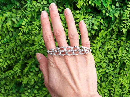 fig 1. An Art Deco platinum bracelet featuring openwork geometric links set with round brilliant diamonds.
