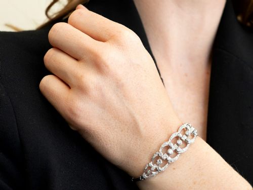 fig 4. An Art Deco platinum bracelet featuring openwork geometric links set with round brilliant diamonds.
