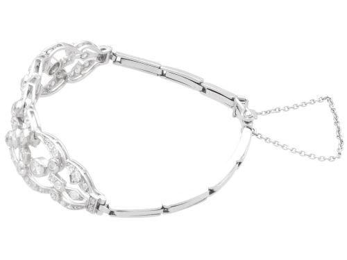fig 6. An Art Deco platinum bracelet featuring openwork geometric links set with round brilliant diamonds.