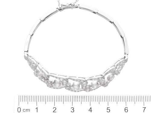 fig 8. An Art Deco platinum bracelet featuring openwork geometric links set with round brilliant diamonds.
