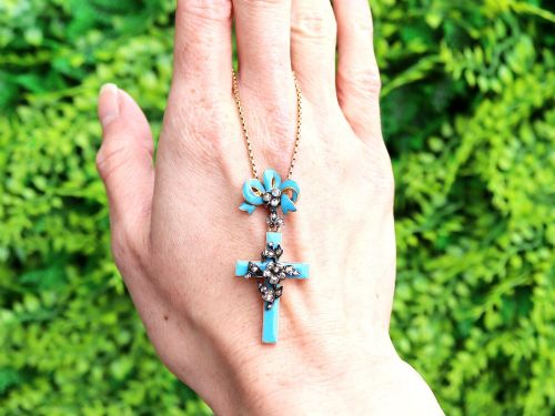 fig 1. A Georgian 15ct yellow gold cross pendant featuring blue enamel, a diamond-set ribbon bow loop, and floral diamond overlays.