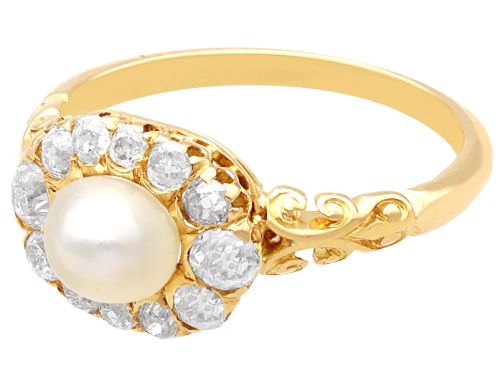 fig 5. An 18ct yellow gold cluster ring featuring a central oval natural pearl surrounded by a halo of old-cut diamonds with scroll-carved shoulders.