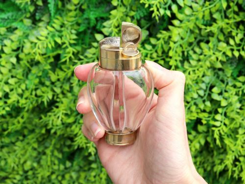 fig 2. A Victorian clear glass scent bottle with fluted sides and engraved sterling silver caps at the top and base.