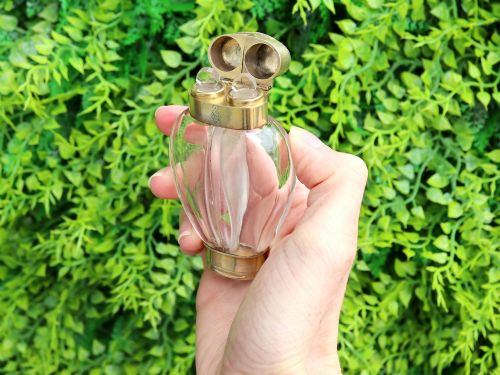 fig 3. A Victorian clear glass scent bottle with fluted sides and engraved sterling silver caps at the top and base.