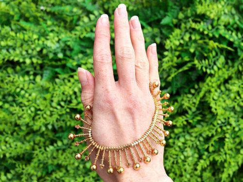 fig 1. An antique 18ct yellow gold Victorian fringe necklace featuring articulated drop elements with spherical ball terminals and beaded details.