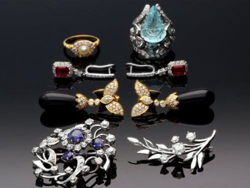 fig 3. An 18ct white gold brooch crafted in the shape of a flowering spray, featuring leaf motifs and claw-set diamonds.