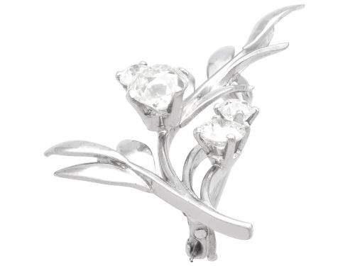 fig 4. An 18ct white gold brooch crafted in the shape of a flowering spray, featuring leaf motifs and claw-set diamonds.