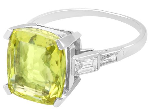 fig 5. An Art Deco platinum ring featuring a large cushion cut yellow chrysoberyl central gemstone flanked by step cut diamonds on the shoulders.