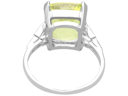 fig 6. An Art Deco platinum ring featuring a large cushion cut yellow chrysoberyl central gemstone flanked by step cut diamonds on the shoulders.