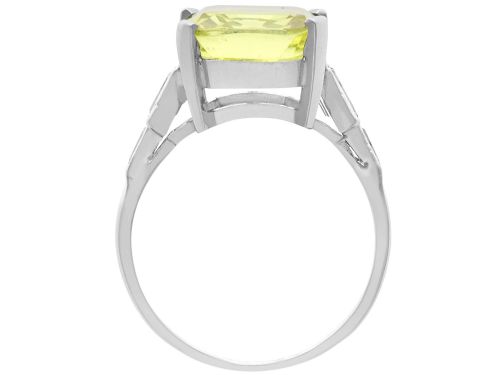 fig 7. An Art Deco platinum ring featuring a large cushion cut yellow chrysoberyl central gemstone flanked by step cut diamonds on the shoulders.