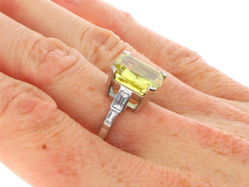 fig 9. An Art Deco platinum ring featuring a large cushion cut yellow chrysoberyl central gemstone flanked by step cut diamonds on the shoulders.