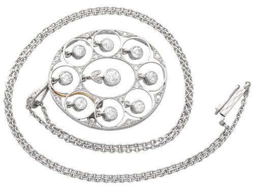 fig 4. An Art Deco circular platinum pendant featuring openwork wirework circles set with diamonds, suspended from a fine chain.