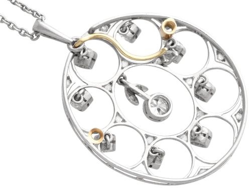 fig 6. An Art Deco circular platinum pendant featuring openwork wirework circles set with diamonds, suspended from a fine chain.