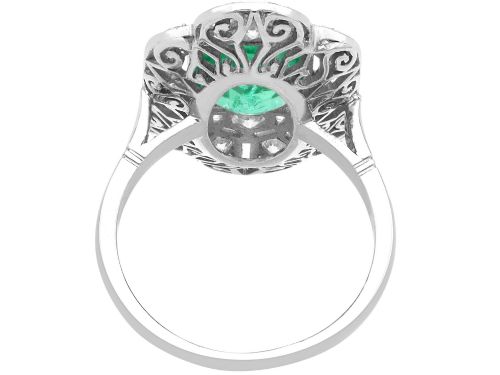 fig 7. An Art Deco platinum dress ring featuring a central rectangular emerald surrounded by an elongated geometric pierced frame set with diamonds.