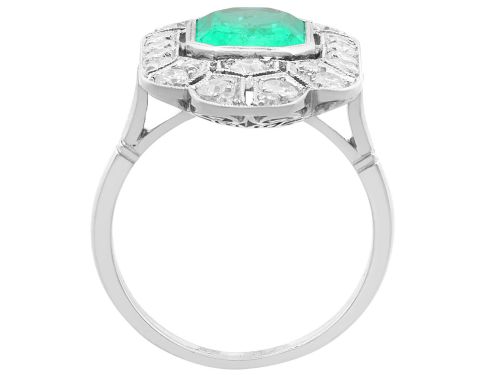 fig 8. An Art Deco platinum dress ring featuring a central rectangular emerald surrounded by an elongated geometric pierced frame set with diamonds.