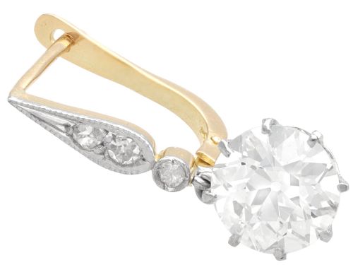fig 3. A pair of antique diamond drop earrings featuring round diamonds suspended from decorative articulated mounts.