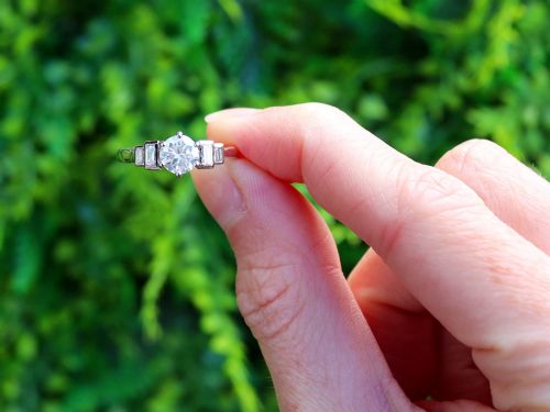 fig 1. An 18ct white gold Art Deco ring featuring a central round diamond flanked by stepped baguette diamond shoulders.