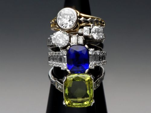 fig 2. An 18ct white gold Art Deco ring featuring a central round diamond flanked by stepped baguette diamond shoulders.