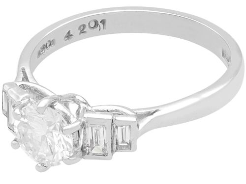 fig 3. An 18ct white gold Art Deco ring featuring a central round diamond flanked by stepped baguette diamond shoulders.