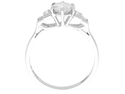 fig 5. An 18ct white gold Art Deco ring featuring a central round diamond flanked by stepped baguette diamond shoulders.