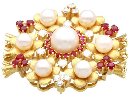 fig 8. An 18ct yellow gold floral cluster brooch set with a central pearl surrounded by small rubies, outer cultured pearls, round diamonds, and red rubies.