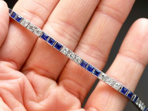fig 4. An Art Deco platinum line bracelet set with alternating square blue sapphires and round brilliant diamonds.