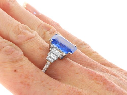 fig 7. An emerald-cut blue sapphire ring set in platinum with stepped baguette diamond shoulders.