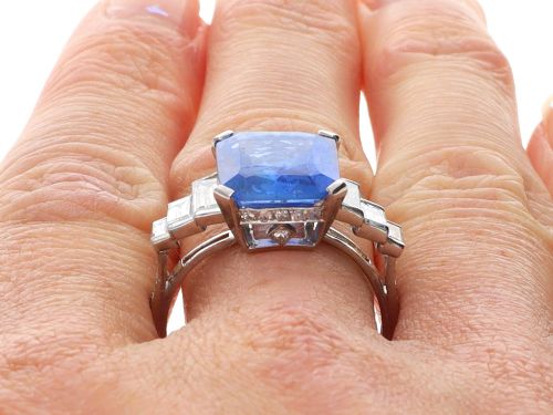 fig 8. An emerald-cut blue sapphire ring set in platinum with stepped baguette diamond shoulders.