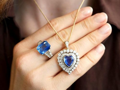 fig 2. A heart-shaped 14ct yellow gold pendant featuring a central heart-cut Ceylon sapphire surrounded by a double halo of brilliant-cut diamonds.