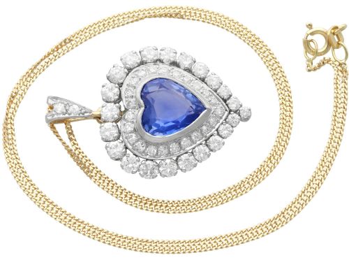 fig 4. A heart-shaped 14ct yellow gold pendant featuring a central heart-cut Ceylon sapphire surrounded by a double halo of brilliant-cut diamonds.