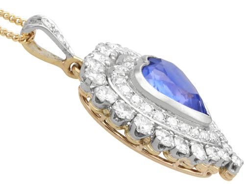 fig 5. A heart-shaped 14ct yellow gold pendant featuring a central heart-cut Ceylon sapphire surrounded by a double halo of brilliant-cut diamonds.