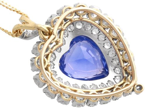 fig 6. A heart-shaped 14ct yellow gold pendant featuring a central heart-cut Ceylon sapphire surrounded by a double halo of brilliant-cut diamonds.