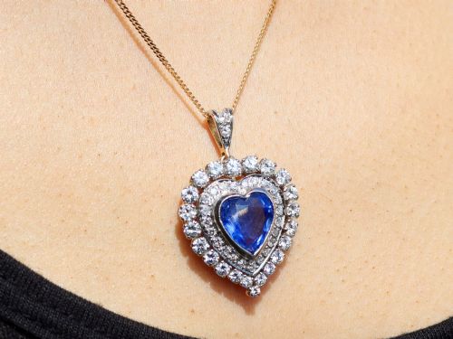 fig 9. A heart-shaped 14ct yellow gold pendant featuring a central heart-cut Ceylon sapphire surrounded by a double halo of brilliant-cut diamonds.