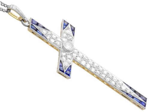 fig 6. An antique Edwardian cross pendant set with diamonds and geometric blue sapphires suspended from a chain.