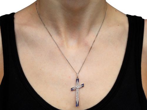 fig 9. An antique Edwardian cross pendant set with diamonds and geometric blue sapphires suspended from a chain.