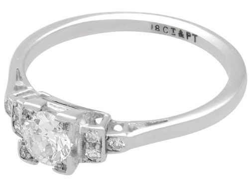 fig 2. An Art Deco white gold and platinum ring featuring a central round diamond with stepped accent diamond shoulders.